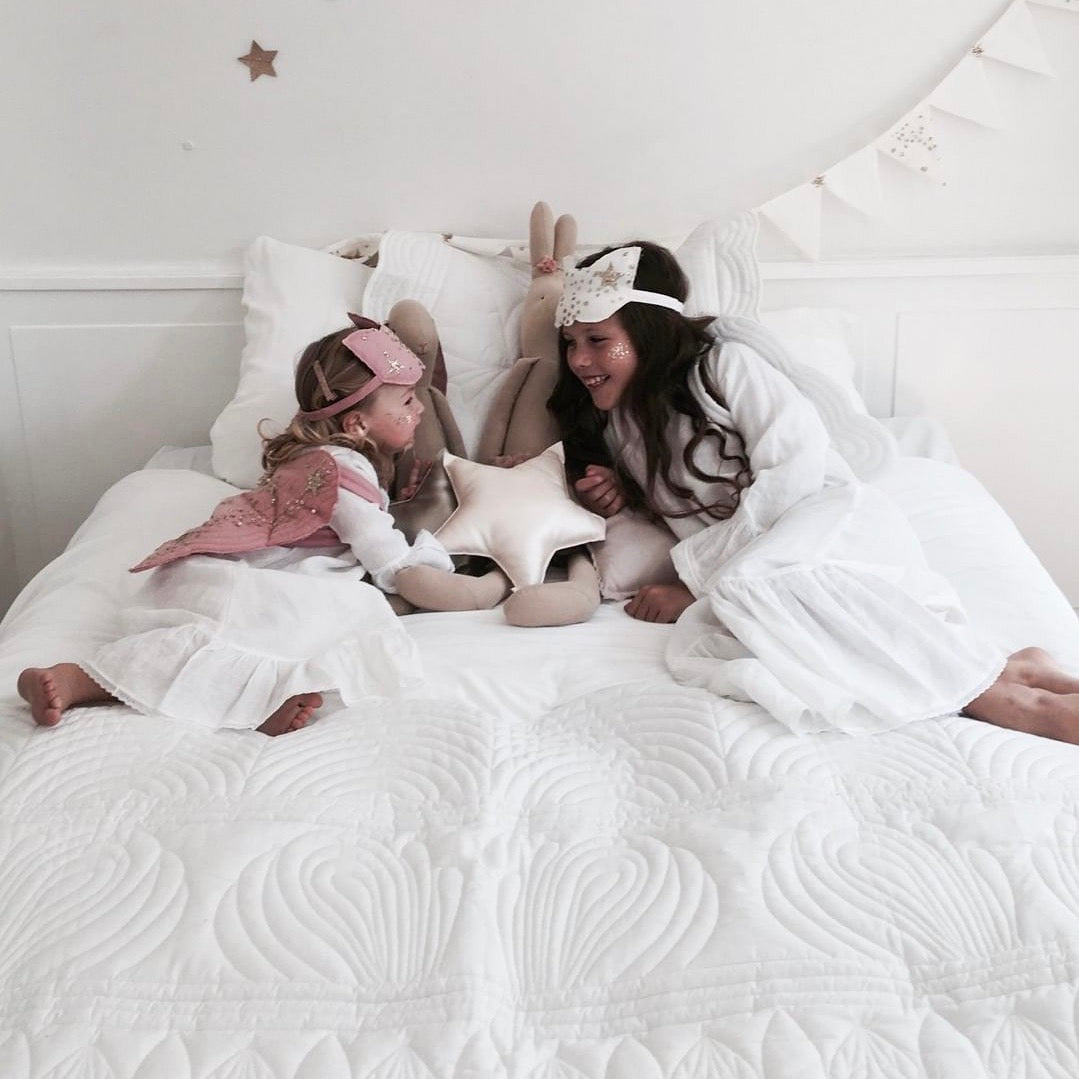 little girls play on mummys bed quilt