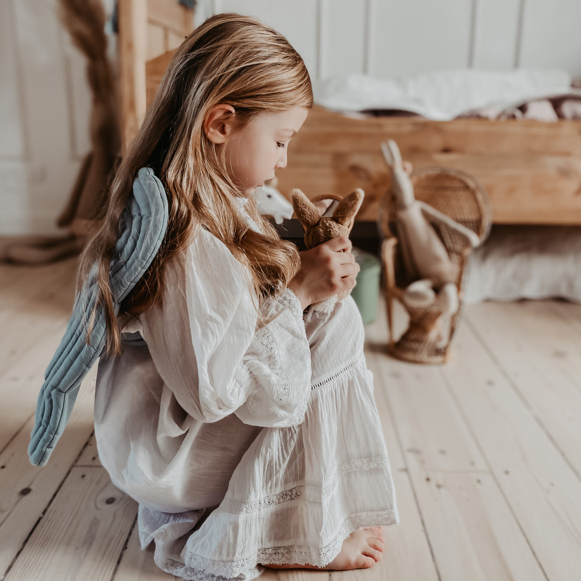 little playing in her quilted fairy angel wings