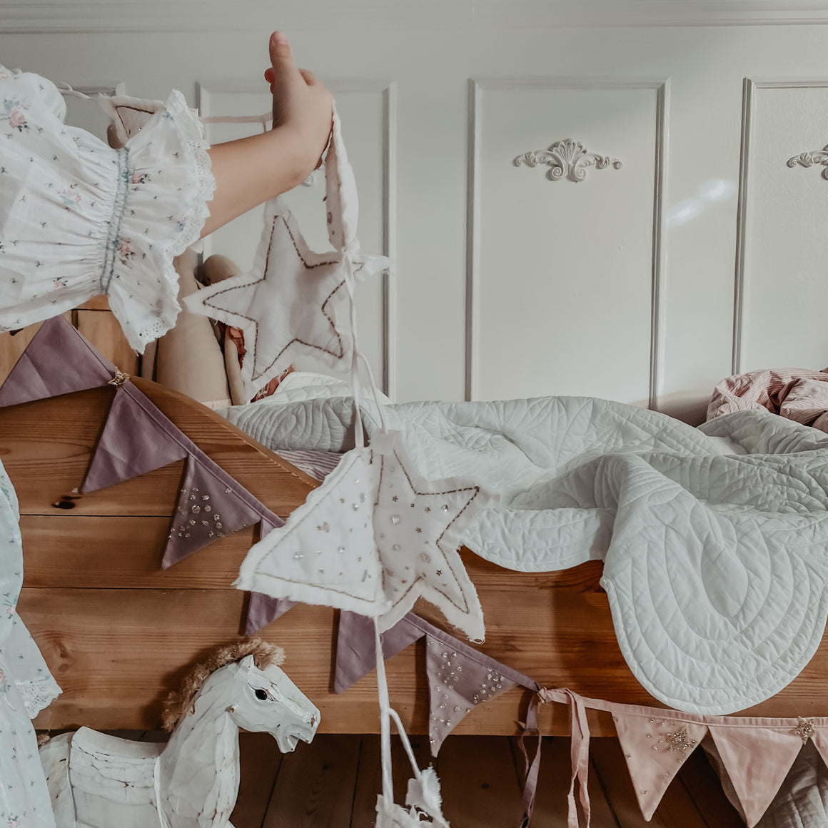 little girl decorating her vintage bed 